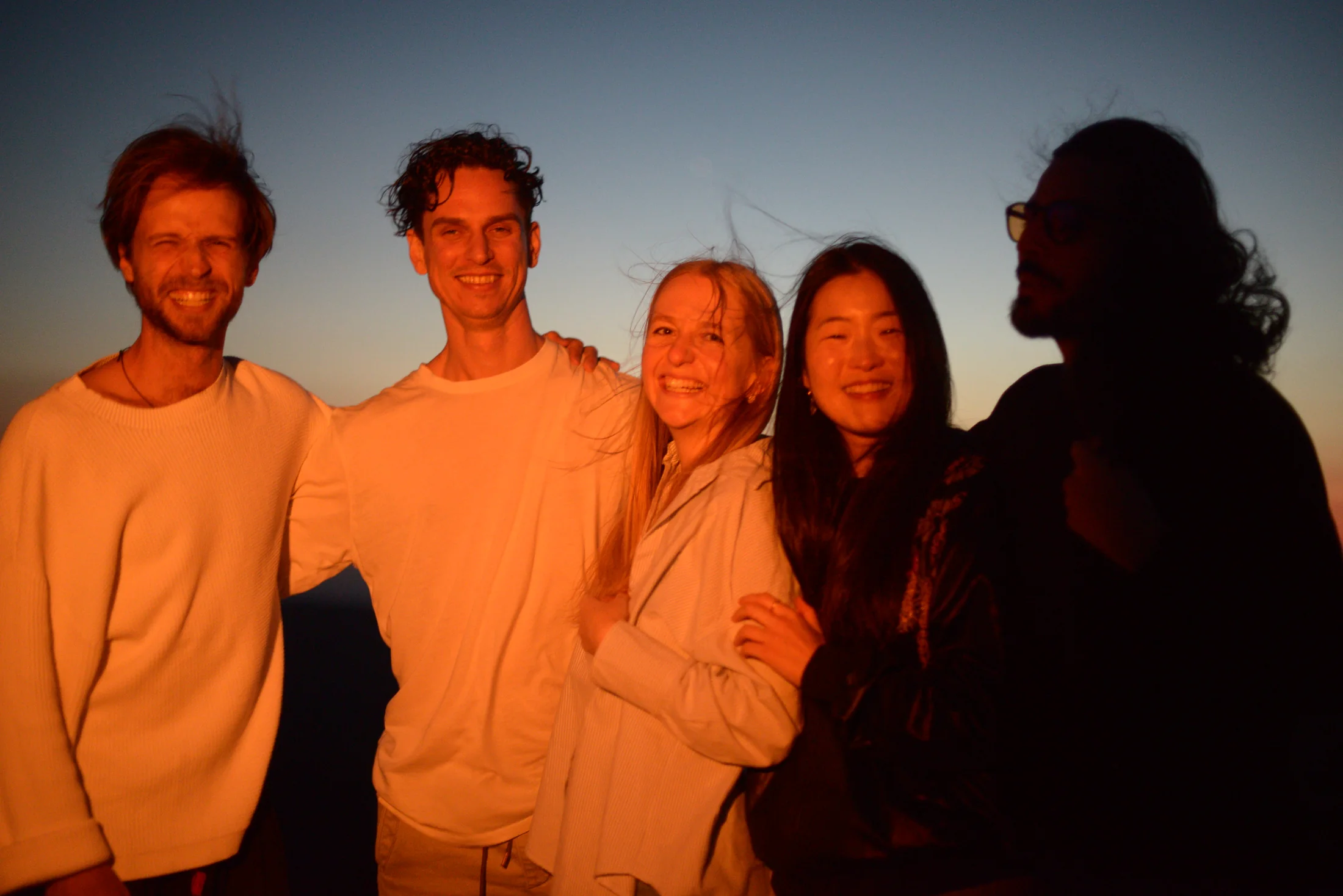 Villa Gaia community members together at sunset