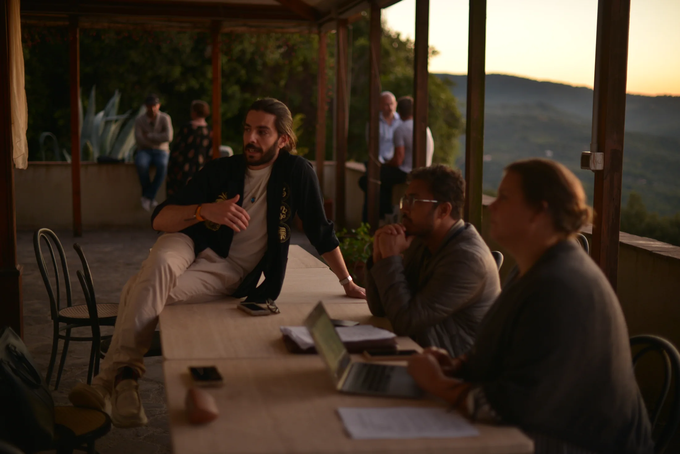 Villa Gaia participants discussing ideas at an outdoor table